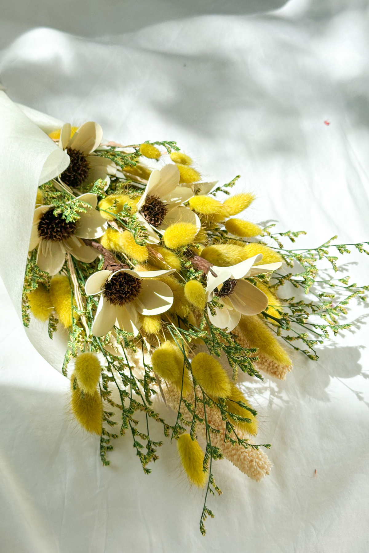 Bouquet of yellow and white flowers on a white background