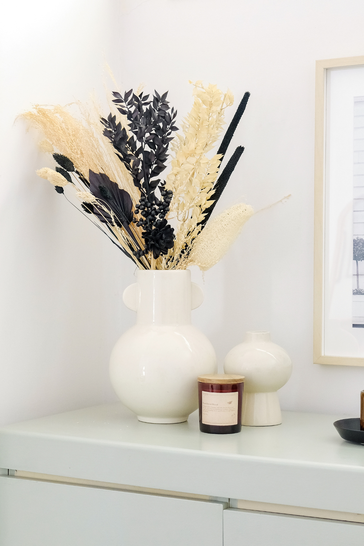Black and white dried flower bouquet styled in a house on a table