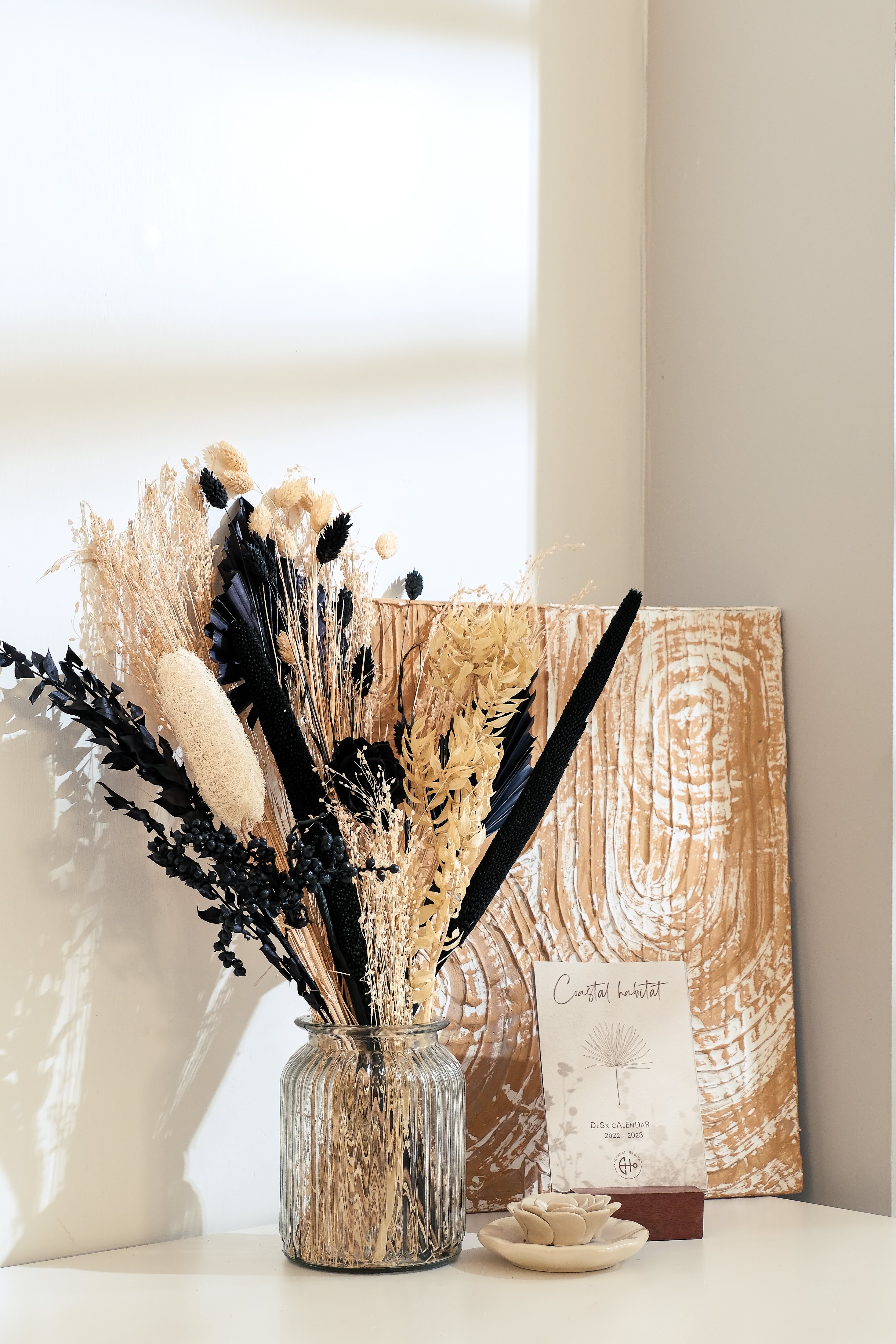 Black and white dried flower bouquet styled in a house